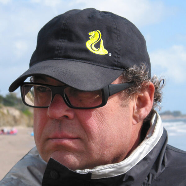 a man wearing eyeglasses and a black hat