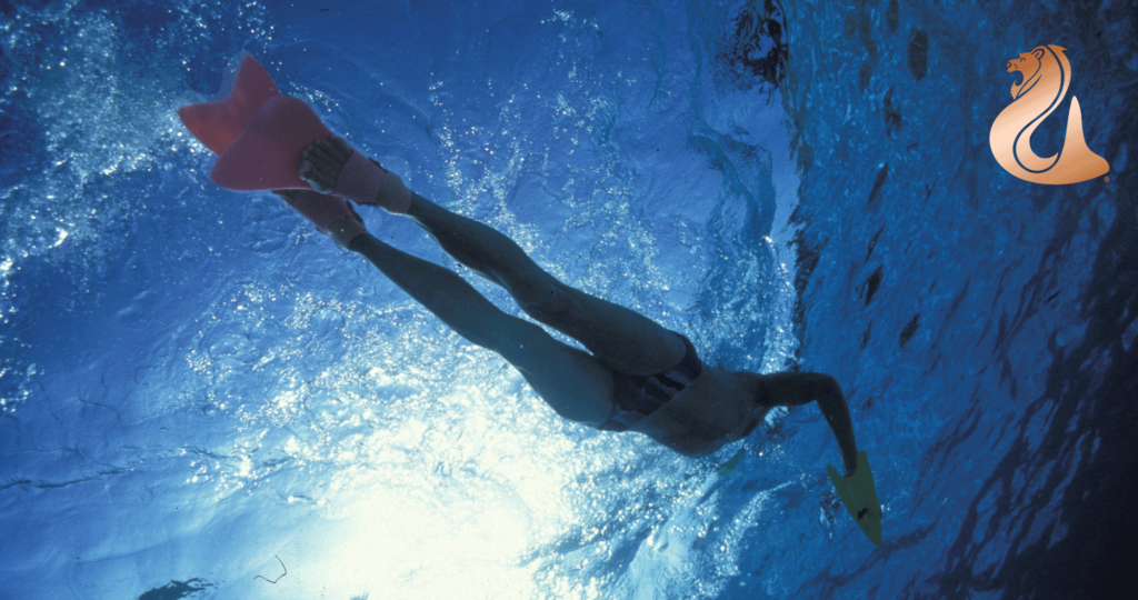a person under water swimming using diving fins